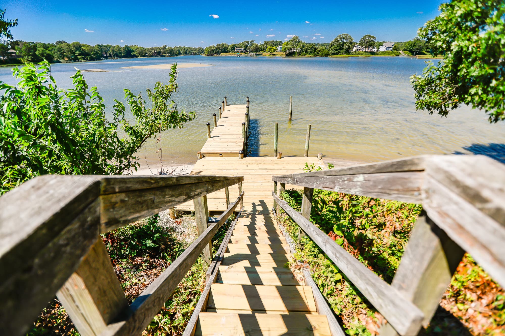 Wooden stairs descending from the cottage down to the private dock and Hull Creek.